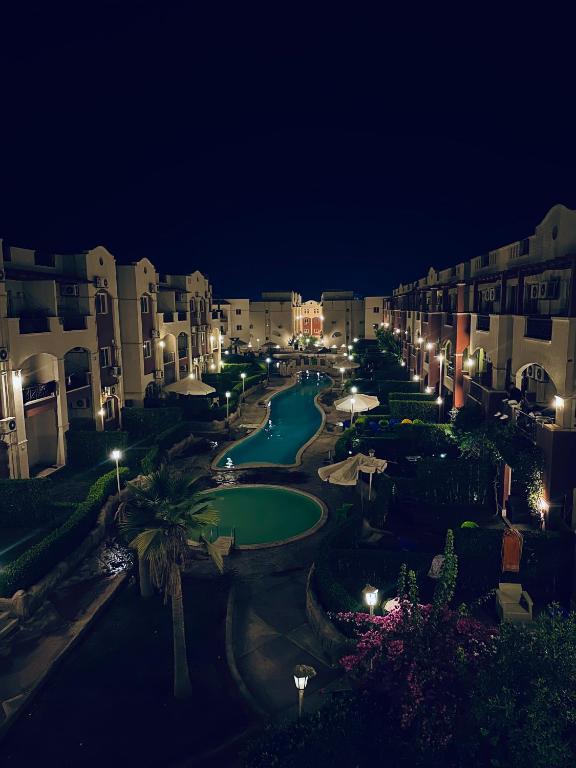 a view of a courtyard at night with buildings at Lasirena in Ain Sokhna