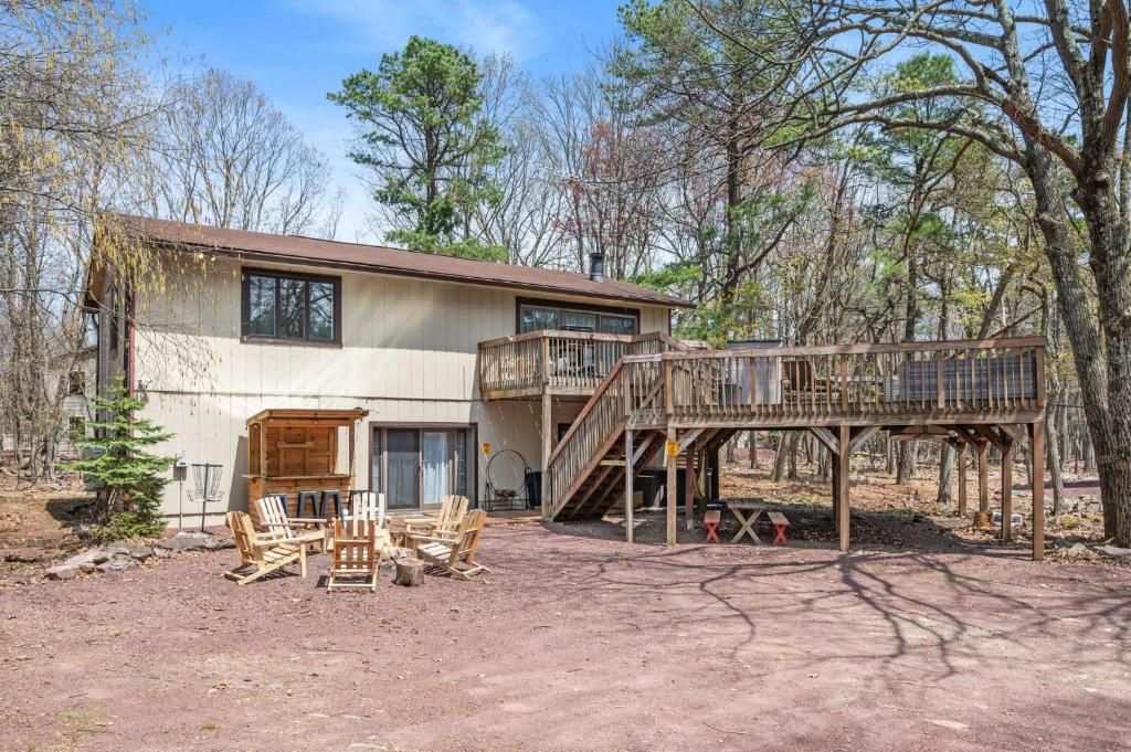 a house with a large deck in front of it at Good Lodge - Hot Tub Beach Access Pool Table in Lake Harmony