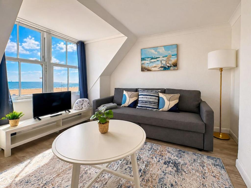 a living room with a couch and a table at Marine Parade - Beach Apartment in Southtown
