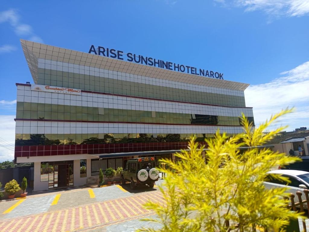 an office building with a sign on it at Arise Sunshine Hotel in Narok