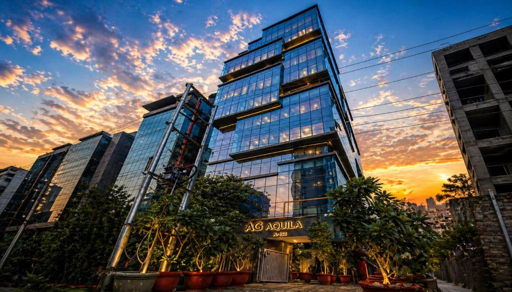 a tall building with trees in front of it at Aquila Grand Suites - Noida Sector 136 in Noida
