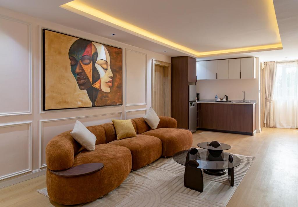 a living room with a couch and a painting on the wall at Seashell Suites in Abuja