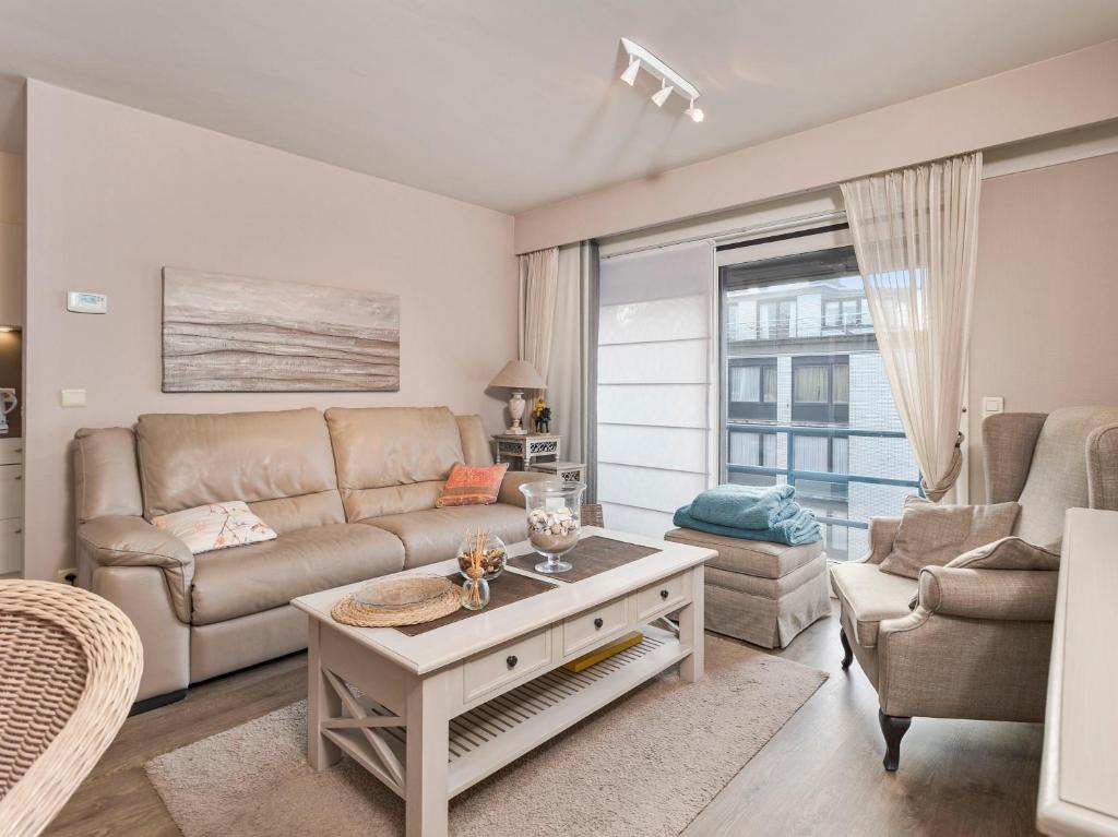 a living room with a couch and a table at Beaufort 0401 in Wenduine