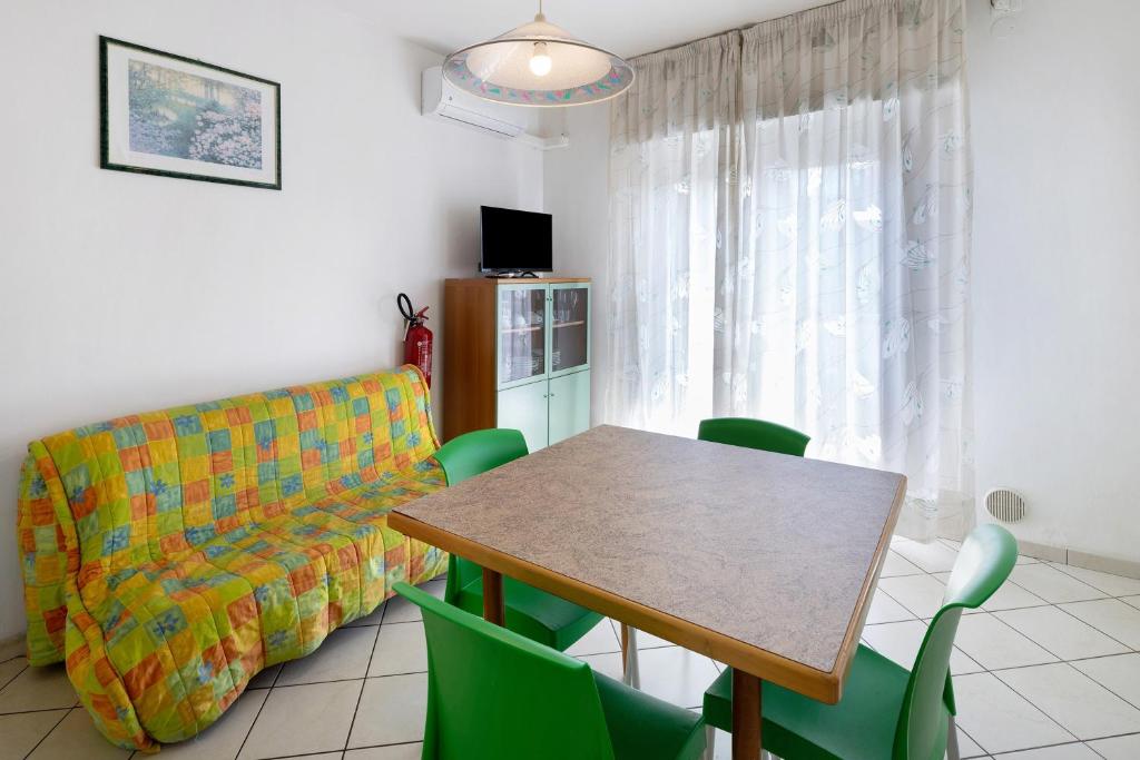 a living room with a table and a couch at Residenza Stella Y in Bibione
