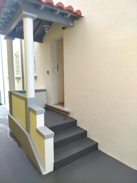 a stairway leading to a building with a stair case at 4-As Andar-Moradia Muralhas in Guimarães
