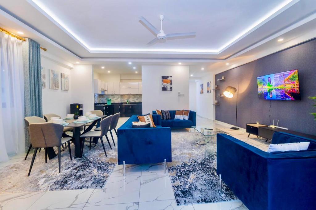 a living room with a table and a blue couch at Seabreeze haven apartment in Mombasa