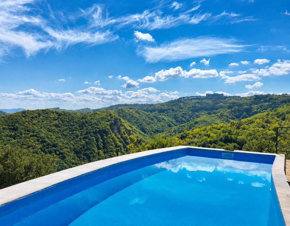 a swimming pool with a view of the mountains at Panorama in Sighnaghi