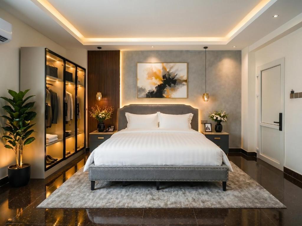 a bedroom with a large bed and a painting on the wall at Soléa Boutique Hotel & Spa By Sol in Ho Chi Minh City