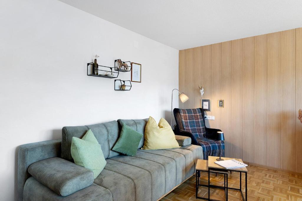 a living room with a couch and a chair at Försterhaus Wohnung Obergeschoss in Egg