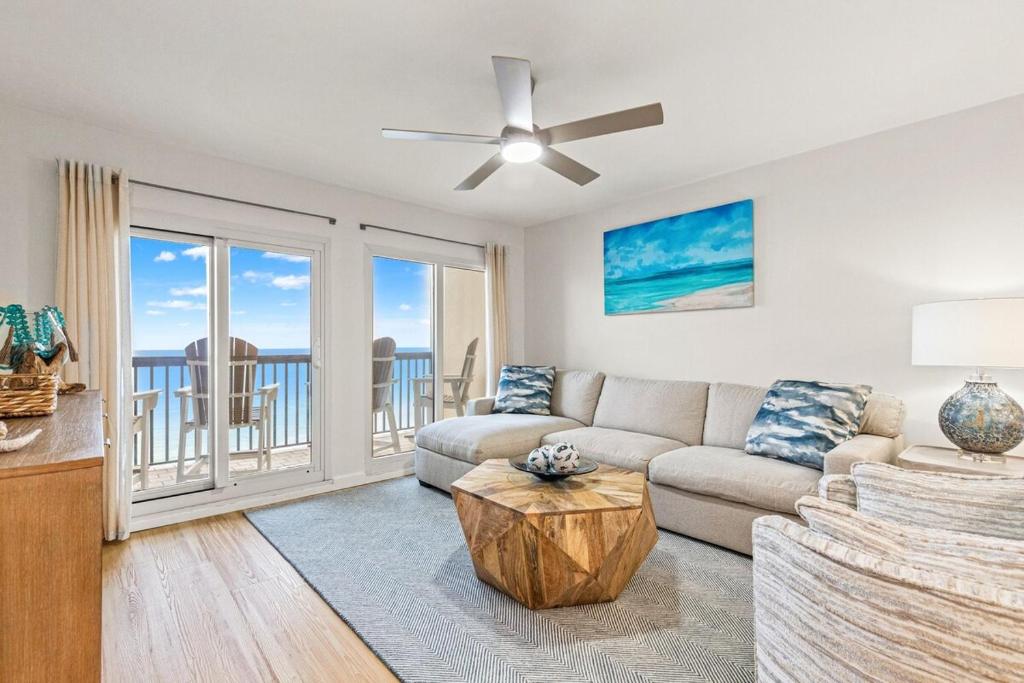 a living room with a couch and a ceiling fan at Pinnacle Port, C2-603 in Panama City Beach
