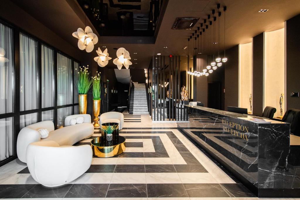 a lobby of a hotel with couches and a bar at Premium Hotel, Novi Sad in Novi Sad