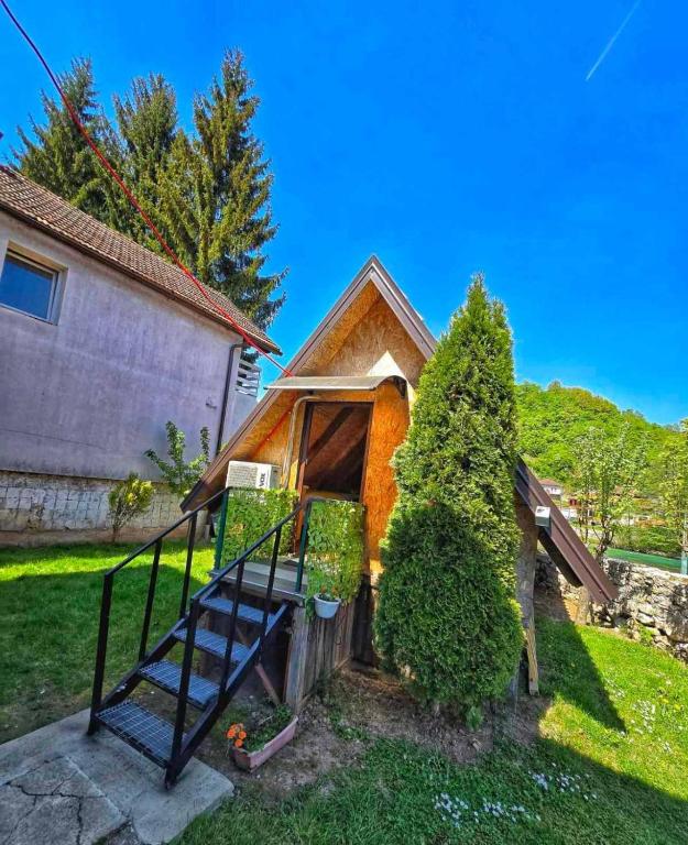 a house with a staircase in the yard at Alfa in Kulen Vakuf