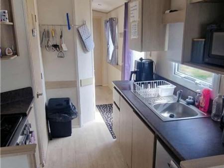 a kitchen with a sink and a counter top at Abi tebay oakfields towyn in Kinmel Bay