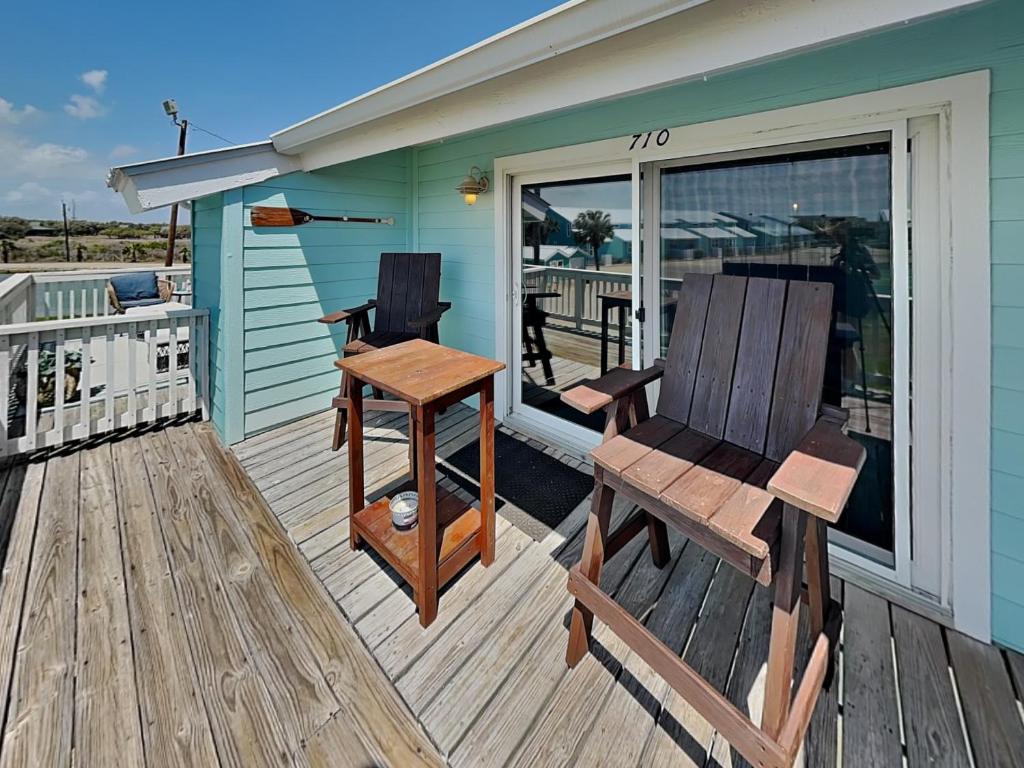a house with a deck with a bench and a table at Kontiki Bayfront Condo #710 in Rockport