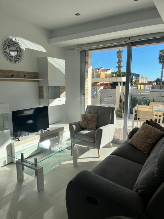 a living room with a couch and a chair at Casa Laguna Torrevieja in Torrevieja