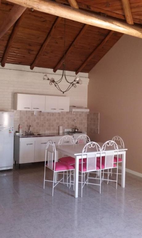a kitchen with a table and chairs in a room at El Sosiego in Trelew