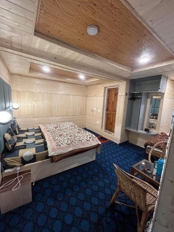 a bedroom with a large bed in a room at Kashmir cottage in Pahalgām