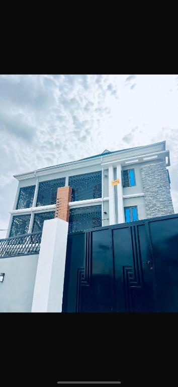a blue and white building with a cross on it at TFE Apartments in Ibadan
