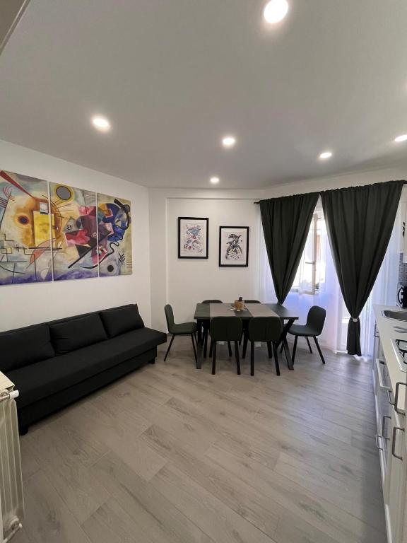 a living room with a black couch and a table at Brothers house in Genzano di Roma