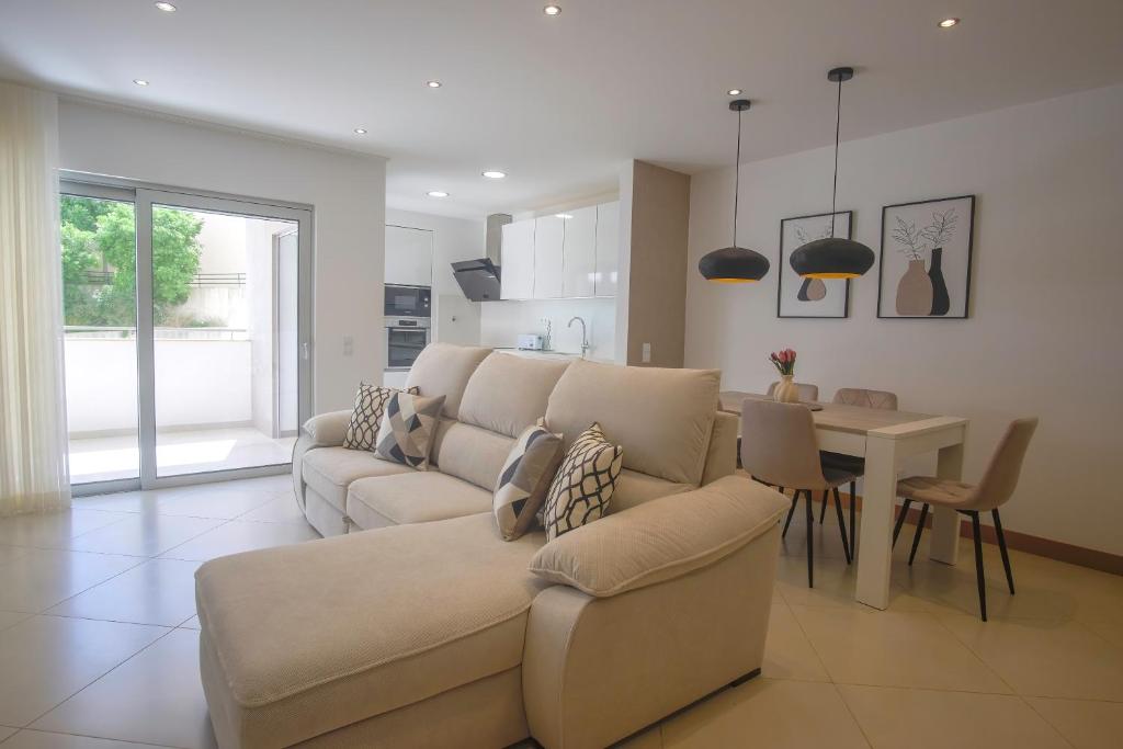 a living room with a couch and a table at Rooftop pool & Luxury apartment in Lagos