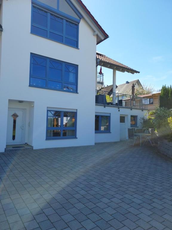 a white house with a patio in front of it at Ferienwohnung Störkle in Maselheim