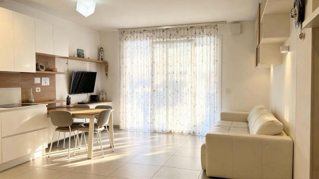 a kitchen and living room with a couch and a table at Marco Polo House in Chioggia