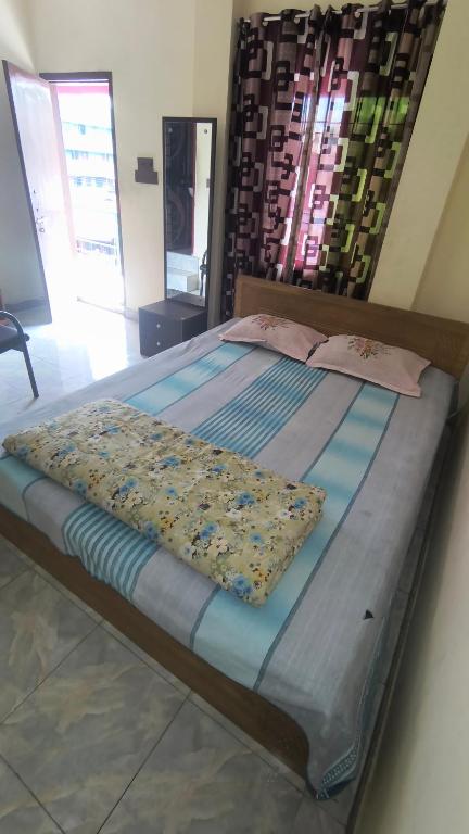 a large bed in a bedroom with at Pauro Abashik Hotel in Khagrāchari