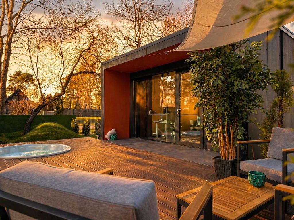 a wooden deck with a table and chairs at Casa Luba in Saulkrasti