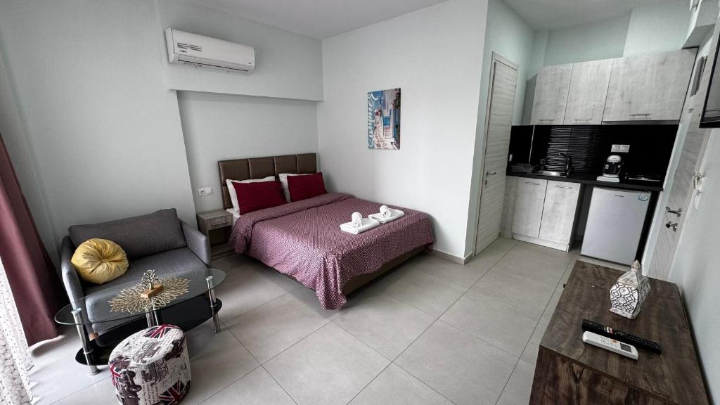 a small bedroom with a bed and a chair at Bella Luxury Suite II in Paralia Katerinis