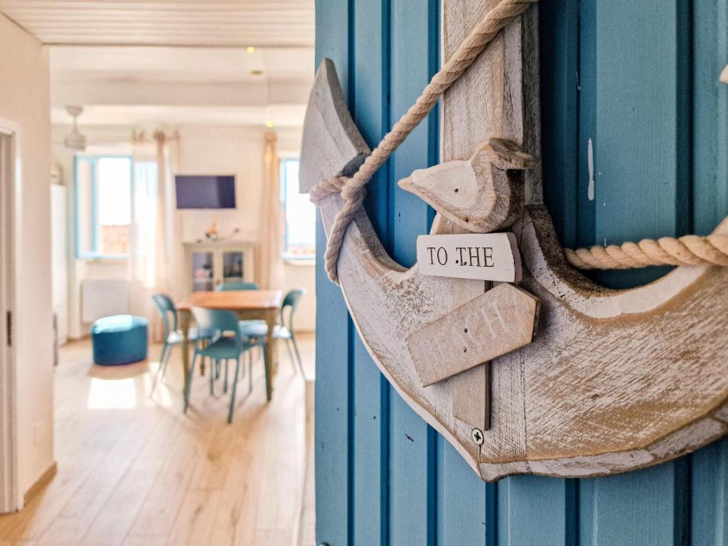 a house with a rope tied to the wall with a living room at Loft Azzurro Old City Center in Rio Marina
