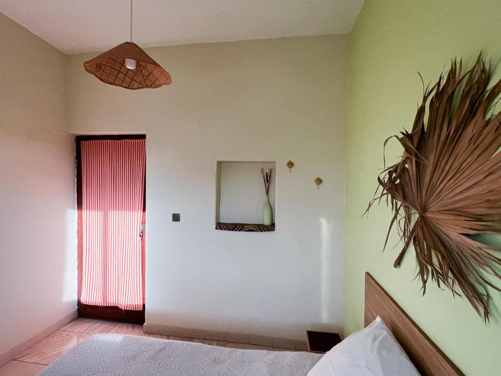 a bedroom with a red door and a mirror at Casa Tota in Assomada