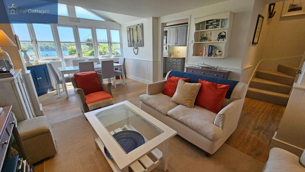 a living room with a couch and a table at The Summer House in Saint Mawes