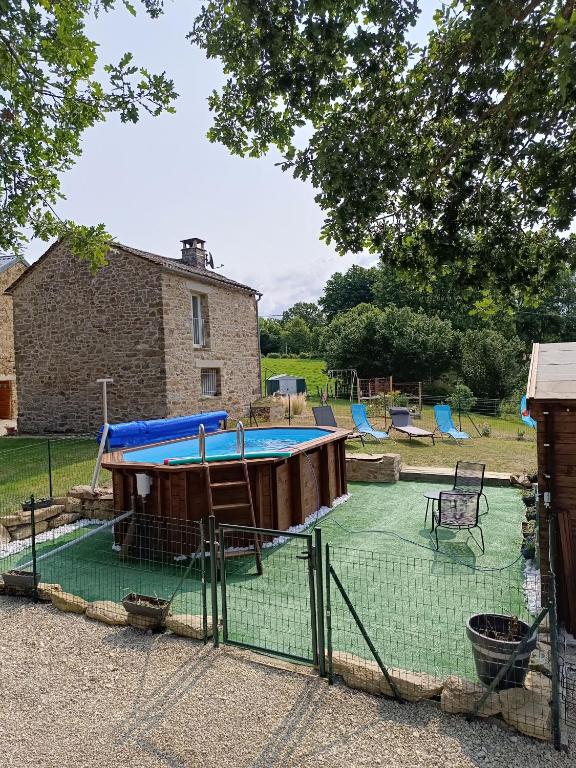 a playground with a trampoline and a pool at La Maison du Cros in Cassagnes-Bégonhès