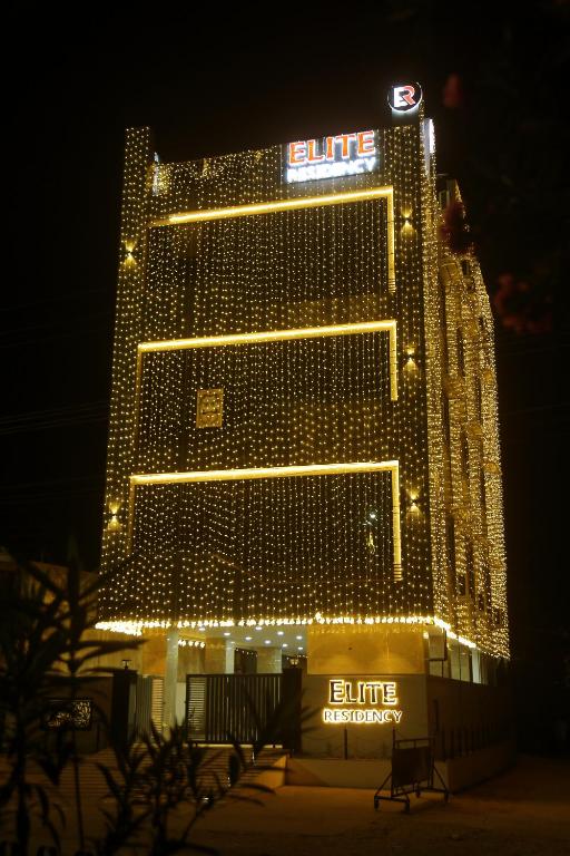 a lit up building with lights on it at night at Elite Residency Bhadrachalam in Bhadrāchalam