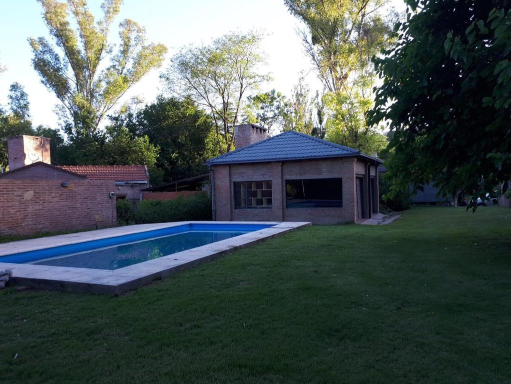 a backyard with a swimming pool in the grass at Casa Fauna in Mendiolaza