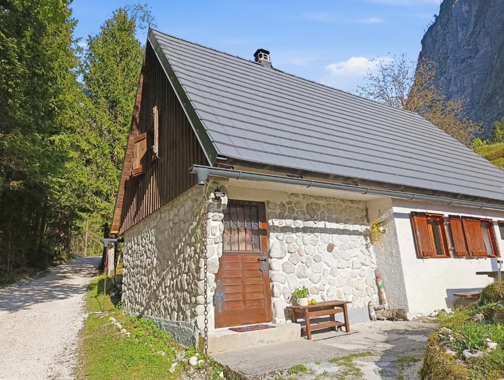 a small stone building with a wooden door at Fairy Tale House in Trenta
