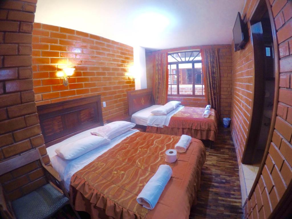 Postel nebo postele na pokoji v ubytování Hostal Nomada