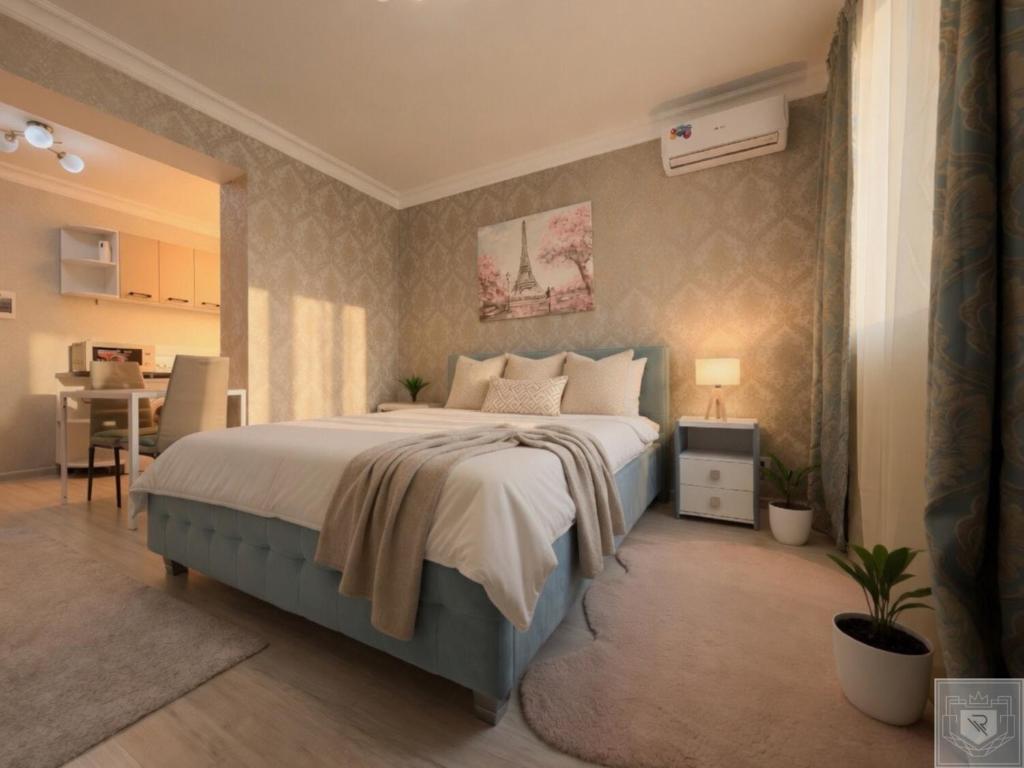 a bedroom with a large bed and a table at RentHouse Apartments Smart-Accomodation in Chişinău