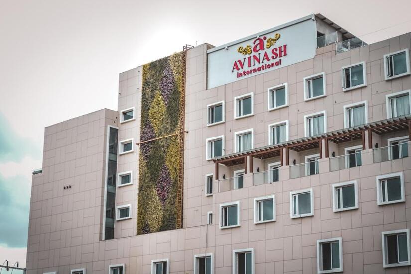 a building with a sign on the side of it at Avinash International in Jagdalpur
