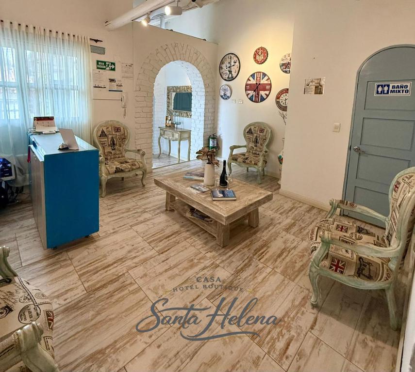 a salon with chairs and a table in a room at HOTEL BOUTIQUE Santa Helena in Villa de Leyva