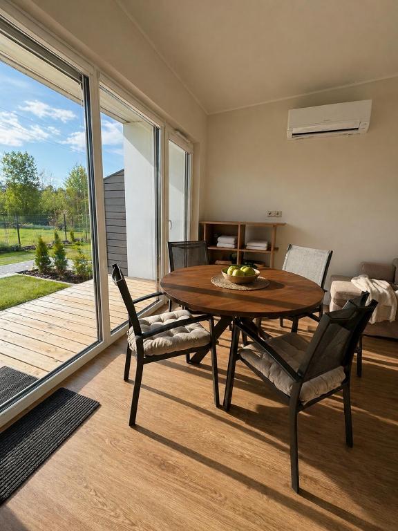 a dining room with a wooden table and chairs at Guest House Klevu 17 in Palanga