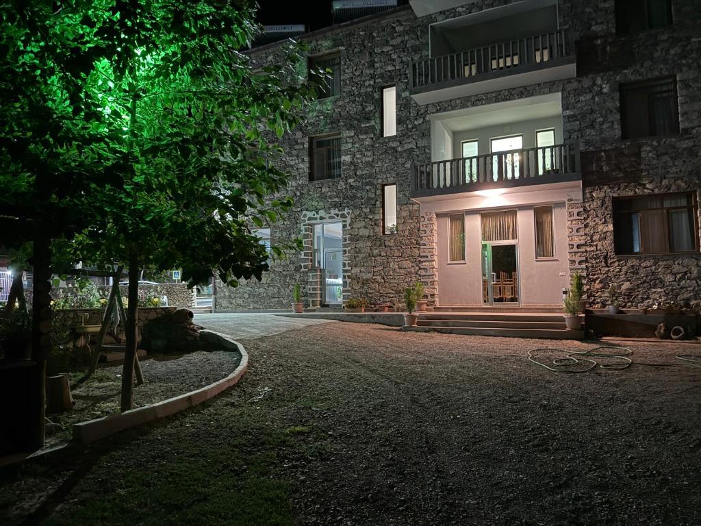 a building at night with a driveway in front of it at Liga Hotel and Restaurant in Shinuhayr