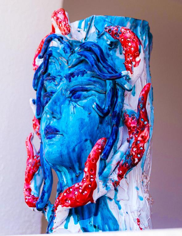 a close up of a statue of a woman with red tentacles at Art Boutique Rooms in Le Castella