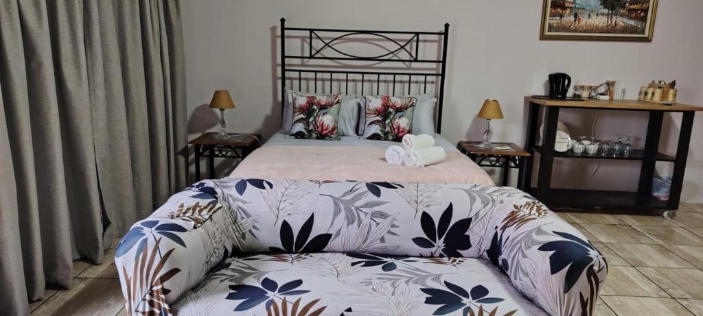 a bedroom with a bed and a couch at Drakensberg Rest in Kimberley
