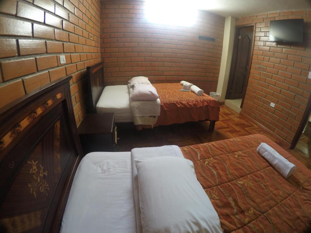 Postel nebo postele na pokoji v ubytování Hostal Nomada