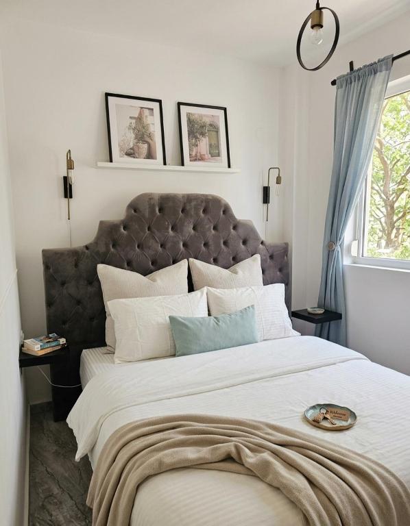 a large bed with a large headboard in a bedroom at Dimi Deluxe in Perea