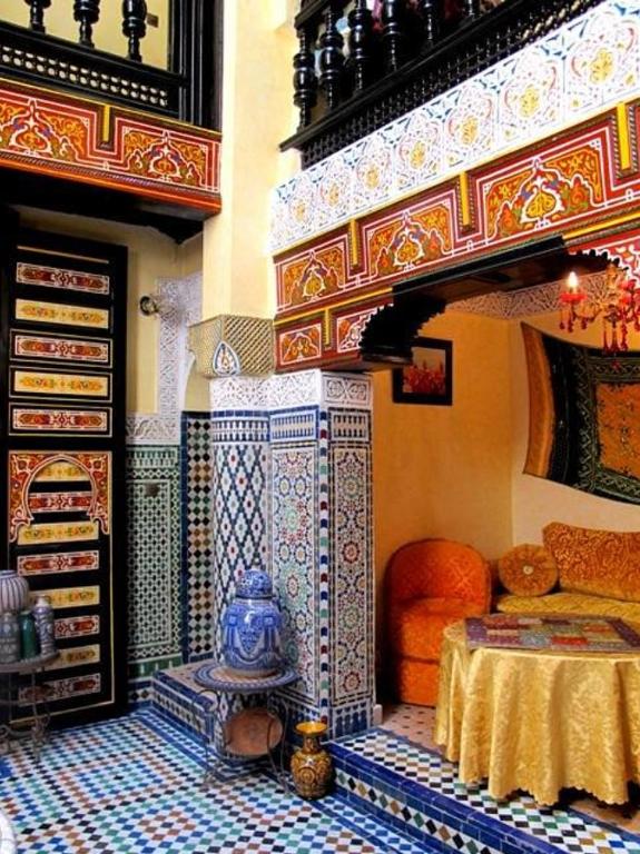 a bedroom with a bed and a table in a room at Palais Doha & SPA in Fez