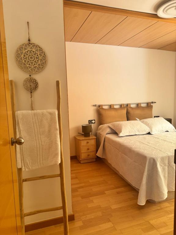 a bedroom with a bed and a wooden floor at Suitte Catalunya in Calafell