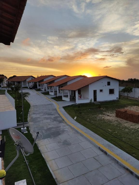 a row of houses with the sunset in the background at Paraíso dos Falcões in Nísia Floresta