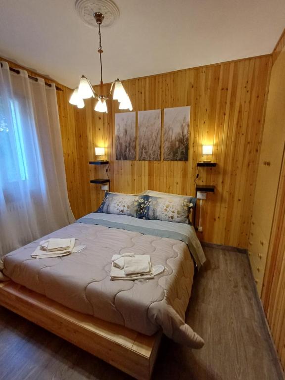 a bedroom with a bed with two towels on it at Eva House 2 in Fanano